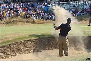 Tiger Woods chips out of a bunker