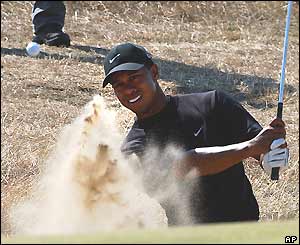 Tiger Woods chips in from a bunker on the seventh