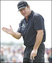 Nick Faldo urges a putt into the hole