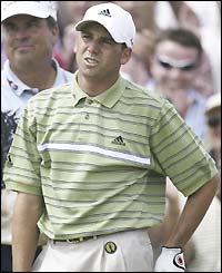 Sergio Garcia grimaces as a shot goes adrift