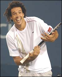 Younes El Aynaoui cradles his racket and smiles after beating Carlos Moya