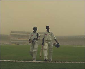The Bangladesh batsmen leave the pitch early on day three for a delay due to a dust storm
