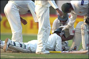 Bangladesh's Alok Kapali lies in pain on the ground after being hit on the head