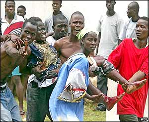 Residents carry a woman wounded during the mortar attack outside the US embassy