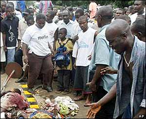 A crowd gathers around the bodies of people killed by mortar shells near the US embassy