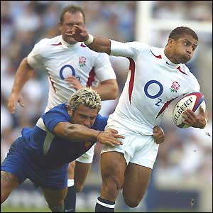 Jason Robinson tries to break free of a tackle