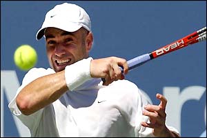 Andre Agassi watches the ball after a forehand