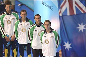 The Australian team stand on the podium after winning the 4x200m freestyle relay gold