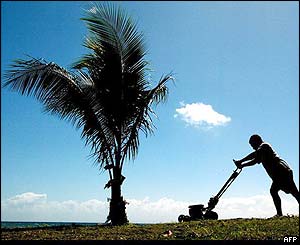 Man mowing the landing strip for the force's aircraft, near Honiara