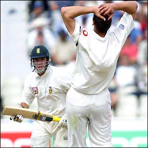 Steve Harmison holds his head as Gibbs goes for a run