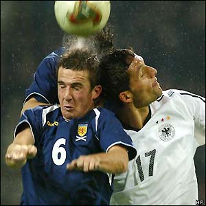Gemany's Kevin Kuranyi and Scotland's Barry Ferguson clash heads as they fight for the ball