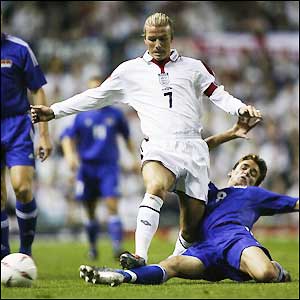 Beckham fights off the Liechtenstein defenders