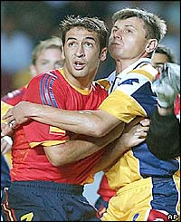 Ukraine's Serhiy Popov hangs on to Spain's Raul Gonzalez 