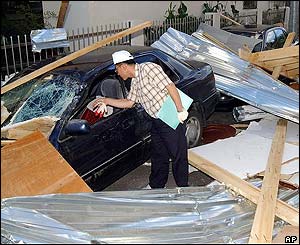 Man looks at a destroyed car in Ulsan