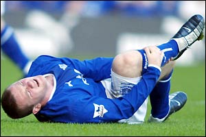 Everton's Wayne Rooney lies injured on the floor against Newcastle