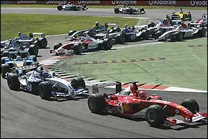 Michael Schumacher in a Ferrari leads the pack away at the start
