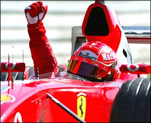 Michael Schumacher punches the air in victory