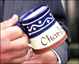 Prince Charles holds the personalised mug he was given 