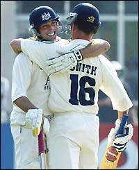 James Averis is congratulated by team-mate Mike Smith after hitting the winning runs for Gloucestershire