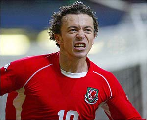Simon Davies celebrates scoring against Italy