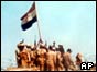 Egyptian soldiers raise their flag in Sinai