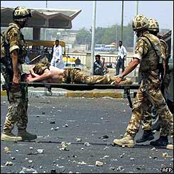 Wounded soldier stretchered off by comrades