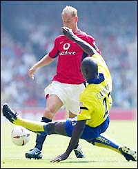 Arsenal's Sol Campbell launches a tackle on Man Utd's Nicky Butt
