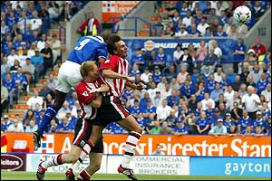 Leicester's Les Ferdinand outjumps the Saints defence to score