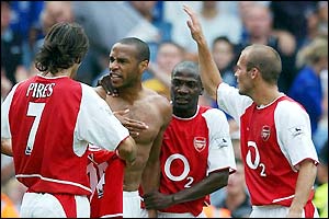 Thierry Henry celebrates with team-mates after opening the scoring