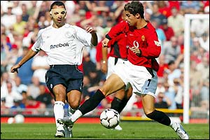 Man Utd's Cristiano Ronaldo holds off Bolton's Youri Djorkaeff