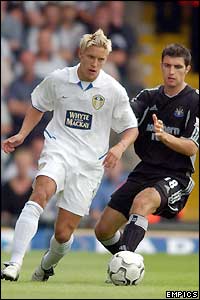 Leeds' Alan Smith tries to dribble past Newcastle's Aaron Hughes