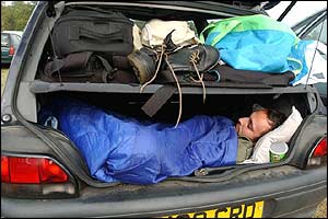 Fan sleeping in car boot