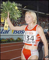Romania's Gabriela Szabo celebrates winning the 3,000m
