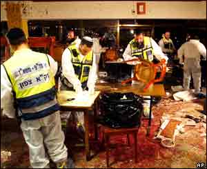 Religious volunteers collect body parts