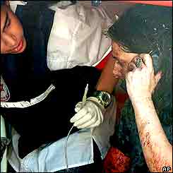 Israeli doctor helping a woman telephoning 