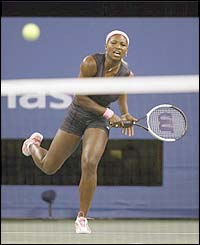 Serena Williams hits the ball towards the net