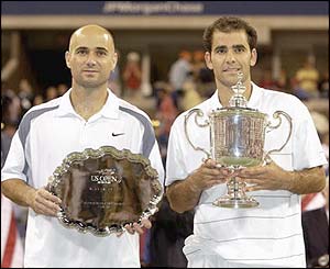Andre Agassi and Pete Sampras pose with their trophies