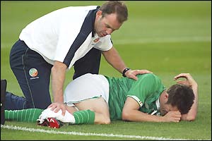 The Irish physio attends to Robbie Keane before the striker is stretchered off late in the first half