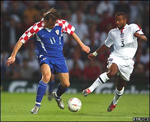 Croatia's Ivica Olic attempts to shield the ball from England left-back Ashley Cole