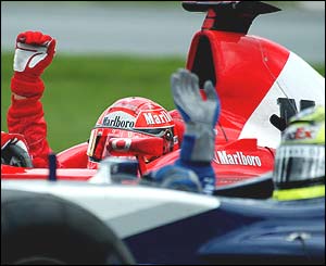 Michael Schumacher and brother Ralf wave to the crowd after the Canadian Grand Prix