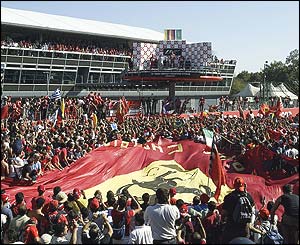 The tifosi cheer as Michael Schumacher, Juan Pablo Montoya and Rubens Barrichello wave from the podium at Monza