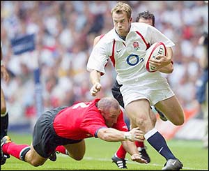 England's James Simpson-Daniel evades a tackle from Robin McBryde