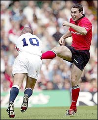 Stephen Jones kicks the ball away from Alex King