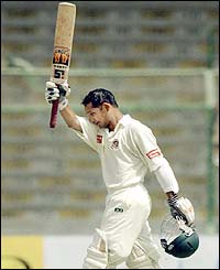Bangladeshi batsman Habibul Bashar raises his bat in celebration after accomplishing a century 
