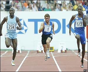 Afghanistan's Assad Ahmadi, centre, competes against Djikoloum Mobele of Chad and France's Issa-Aime Nthepe in the men's 100m heats
