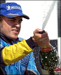 Alonso celebrates on the podium as he becomes the 8th different winner of a Grand Prix this season