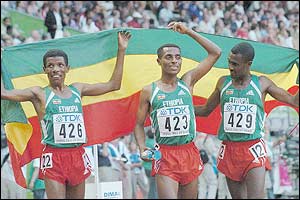 Gold medallist Kenenisa Bekele celebrates with Haile Gebrselassie (left) and Sileshi Sihine (right)