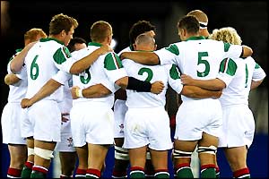 The Welsh side get into a huddle to observe the one minute silence