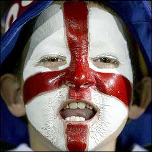 A young English fan cheers his team 