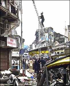 A fireman inspects a damaged building